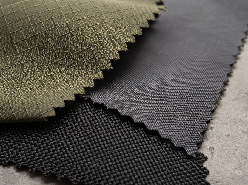 Close-up of ripstop nylon, polyester denier fabric, and ballistic nylon weave textures for fabric construction comparison