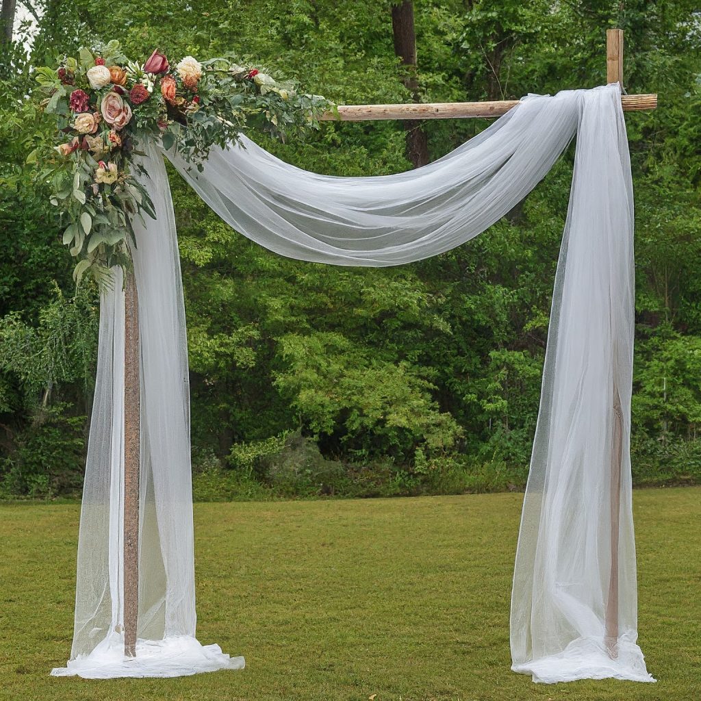 Sheer fabric and floral accents create a romantic pipe and drape wedding archway.