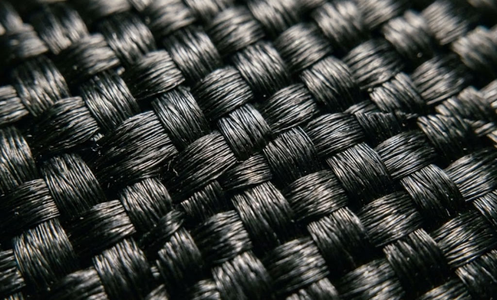 Close-up macro view of 1680D ballistic nylon 2x2 basketweave structure showing thick synthetic polymer threads for chew-resistant dog beds.
