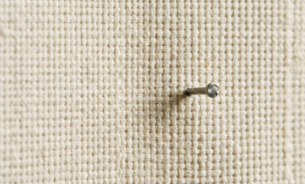Detailed texture of 12oz cotton duck canvas demonstrating the tight over-under plain-weave that resists canine claw abrasion and digging.