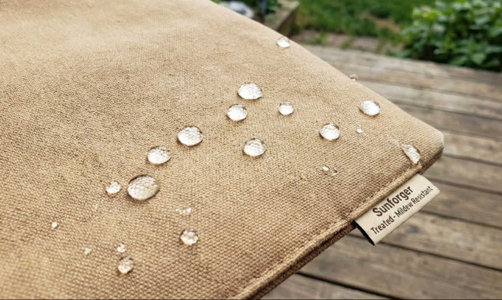Water beading on Sunforger treated heavy cotton duck canvas demonstrating hydrophobic mildew-resistant properties.