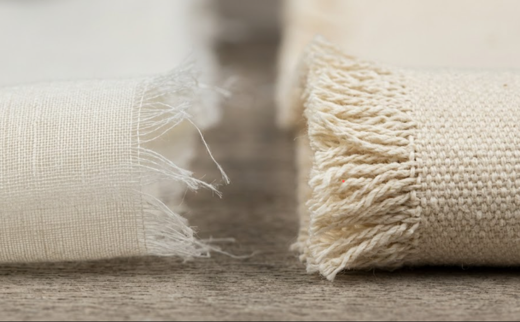 Side-by-side macro comparison of sheer lightweight voile and 10 oz heavyweight cotton duck canvas illustrating GSM density differences.