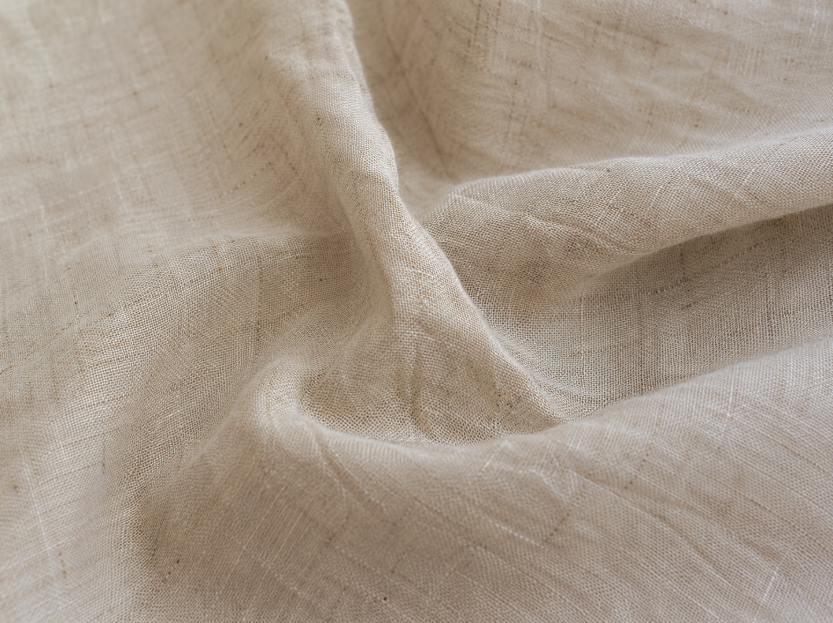 Close-up of wrinkled linen fabric showing natural creases and flax weave texture