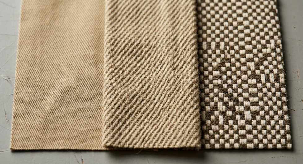 Extreme macro comparison of 3/1 steep twill combed chino cloth showing fine diagonal wales alongside coarse carded cotton utility twill and plain weave duck canvas.